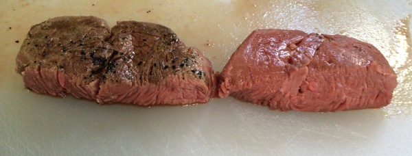 The final product cut in half to show cross-section. Both steaks are evenly done all the way through, with the seared steak having the familiar brownish color on the surface.