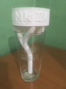 Shows printed siphon atop of pint glass.